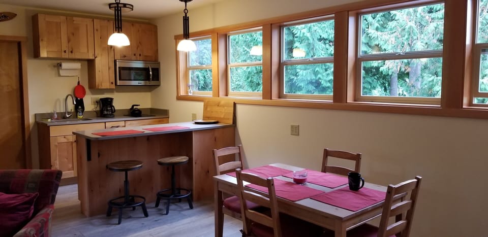 Kitchen/dining area. Seating for six.  Four at the table and two at the counter.