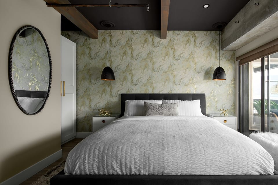 Luxurious king bed with floor to ceiling windows looking out over the lake