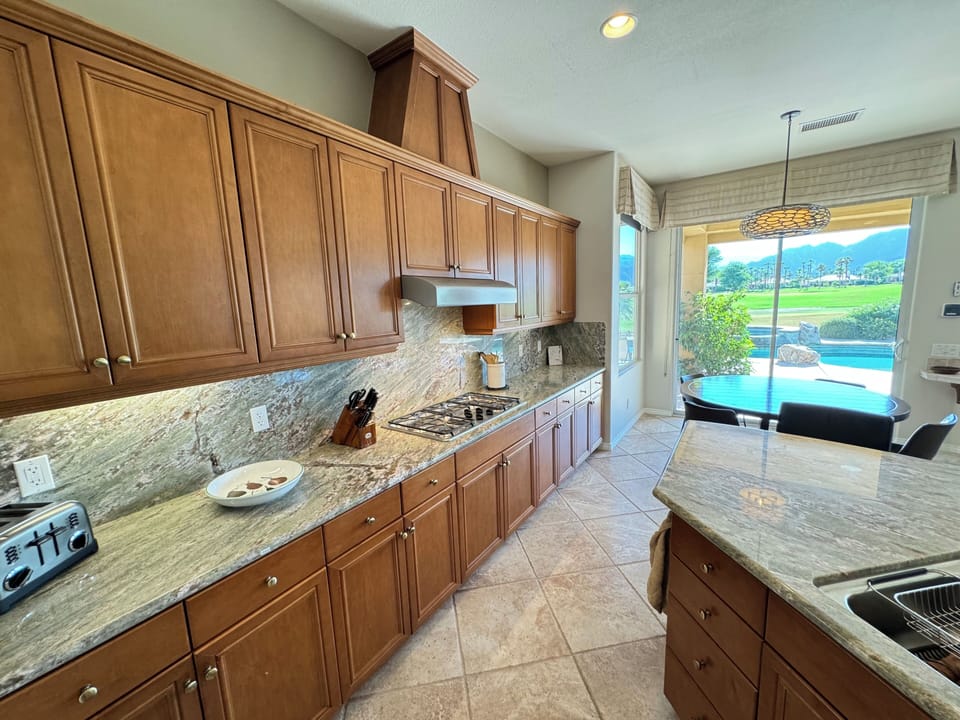 Kitchen has plenty of stocked cabinets, with indoor and outdoor ware.