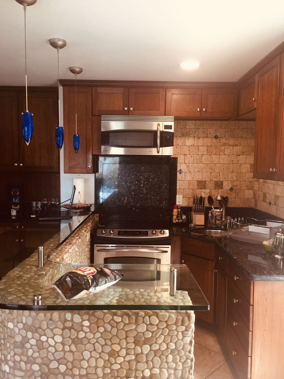 Full kitchen with 4 burner stove and conventional microwave oven