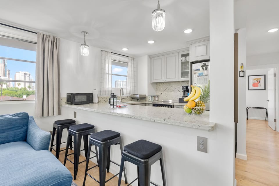 Full kitchen with quartz countertops & stainless steel appliances.