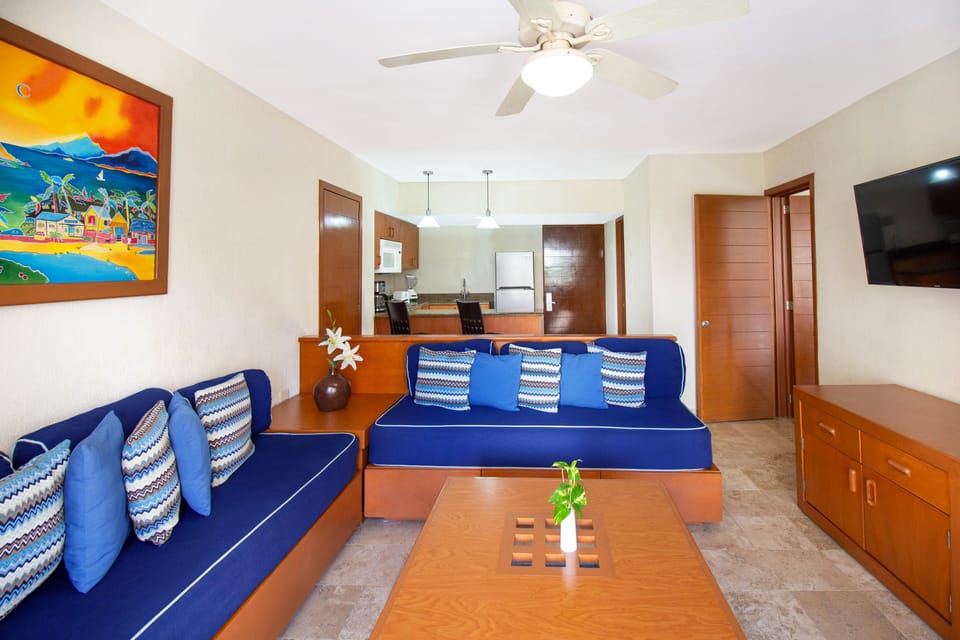 Two Bedroom Family Suite Pool View | Living area | 32-inch flat-screen TV with cable channels, TV