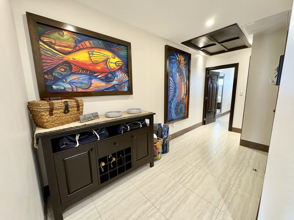 Entry with umbrellas, flashlights, beach bags, luggage scale and pool/beach toys