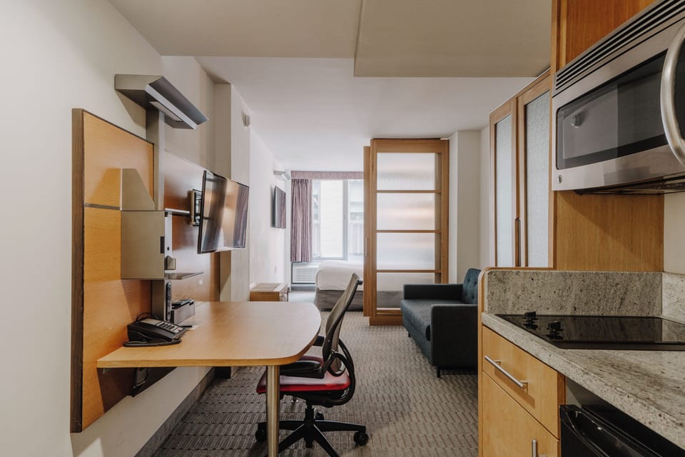 Deluxe Suite, 1 Queen Bed, Kitchenette | Premium bedding, in-room safe, desk, laptop workspace