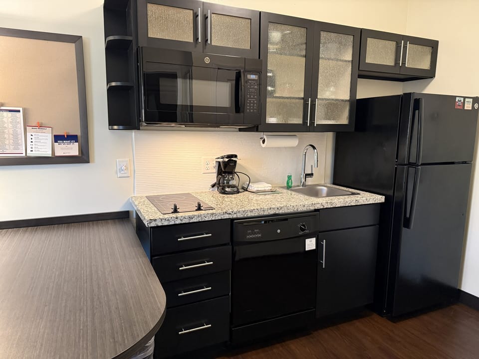 Studio Suite, 1 Queen Bed | Private kitchen | Full-size fridge, microwave, stovetop, dishwasher