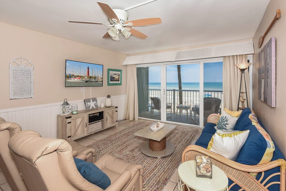 The living room features a queen sofa sleeper, two recliners and large flat-screen TV.