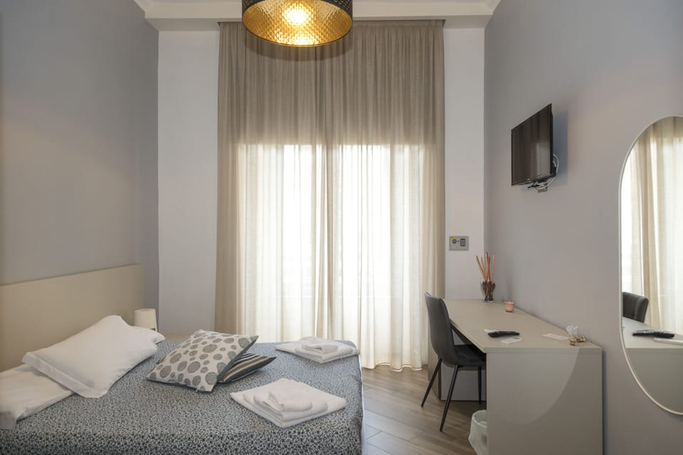 Deluxe Quadruple Room | In-room safe, desk, laptop workspace, blackout drapes