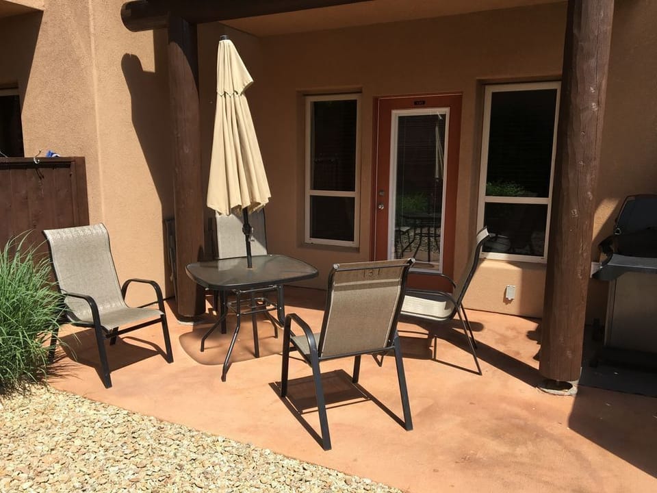 Private Patio with Outdoor Dining Table, Chairs, Umbrella & BBQ