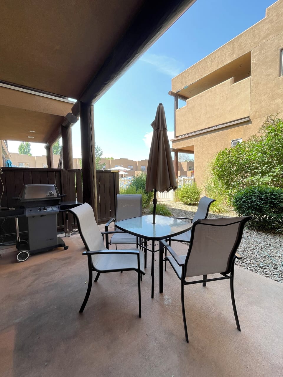 Private Condo Patio with Outdoor Dining Table, Chairs, Umbrella & BBQ