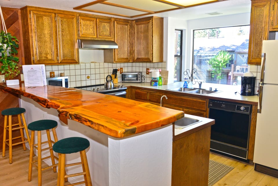Kitchen w/ bar seating.