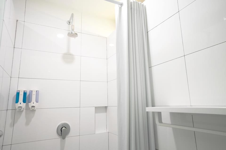 Shower, hair dryer, slippers, towels