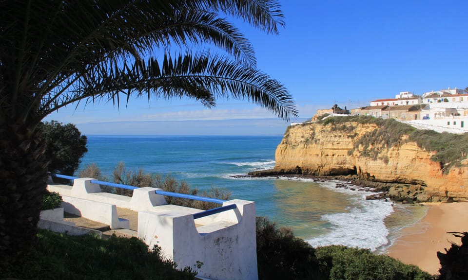 Beautiful sea view with palm trees overlooking the Carvoeiro coastline and golden cliffs near Casa Santalena villa in the Algarve, Portugal