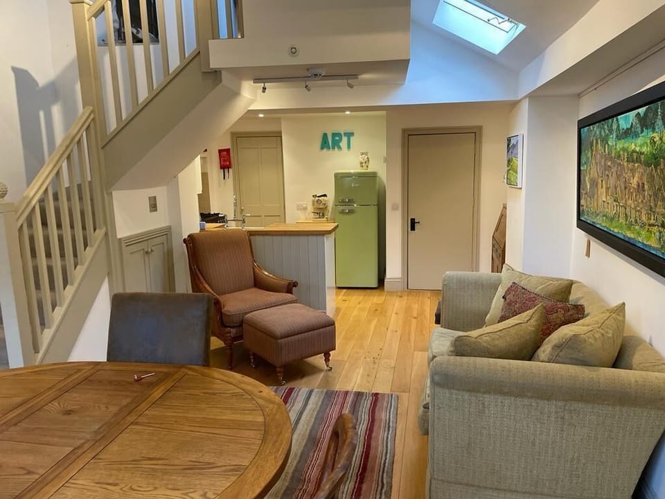 Living room and kitchen with access to upper floors.

