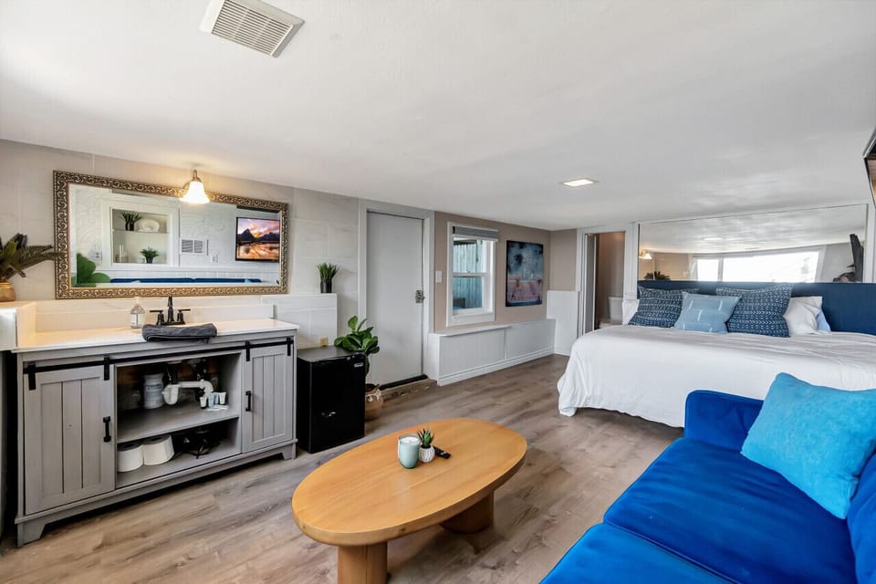 Open-concept layout blending sleeping space, lounge area & workspace.