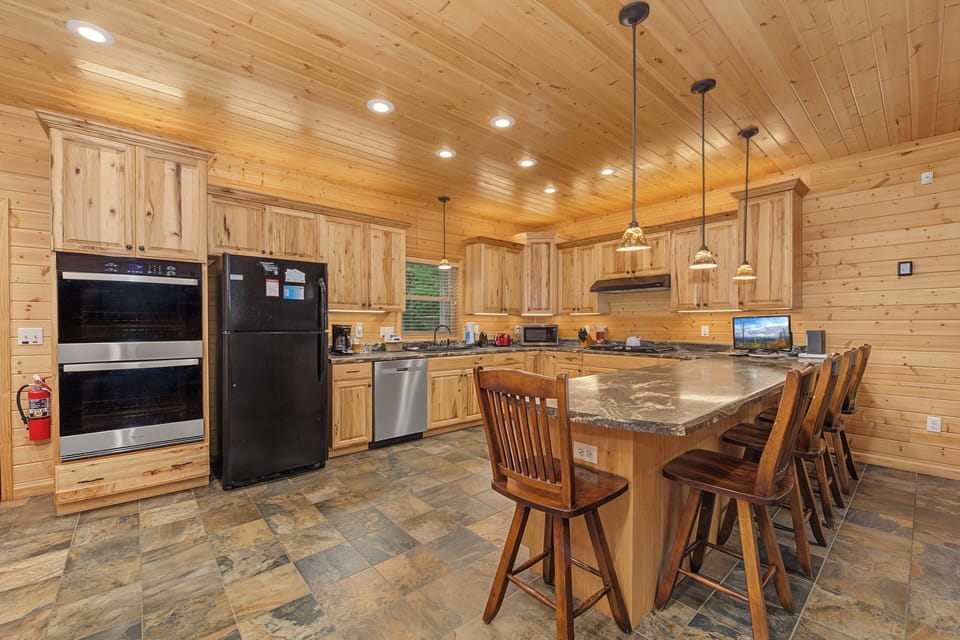 Your gourmet kitchen features granite countertops, stainless appliances, and a spacious island with bar seating—perfect for preparing memorable meals and gathering with loved ones.