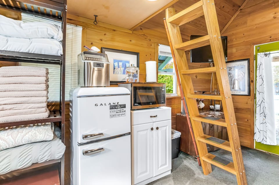 Compact but fully equipped kitchenette with fridge, microwave, ice maker, and pantry storage. Everything you need for a cozy East Hill cottage stay