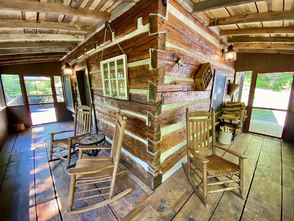 Screened porch with rockers and 18" wide planed flooring - great space to relax!