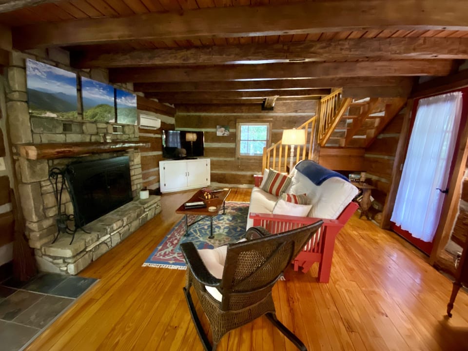 Living Room featuring queen-size futon with available linens (wide-angle view).