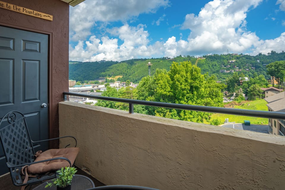 Step outside to your private balcony and take in sweeping views of lush hillsides, vibrant greenery, and the charming neighborhood below—your peaceful retreat awaits.