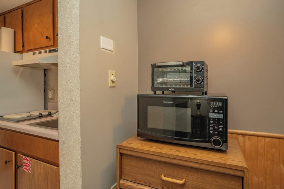 Your kitchenette comes fully equipped with a microwave and toaster oven, perfect for preparing quick meals or snacks during your stay.