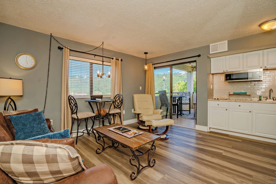 Step into your bright, open-concept retreat where natural light pours through large windows revealing mountain views. Relax in the cozy living area or enjoy meals by the balcony, with modern kitchen amenities close at hand.