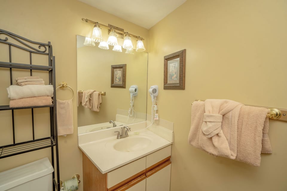 Your private bathroom offers soft lighting, fresh towels, and a welcoming vanity where you can comfortably get ready for the day ahead.
