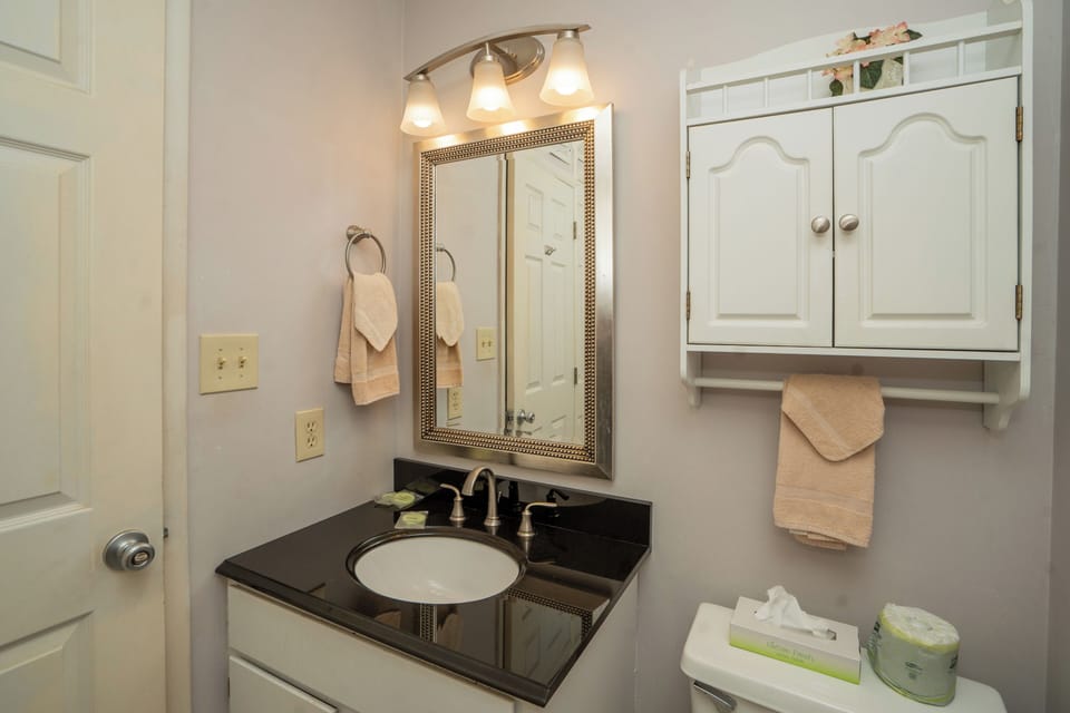 Freshen up in your private bathroom, where thoughtfully arranged towels and elegant fixtures create a welcoming retreat after a day of exploring.