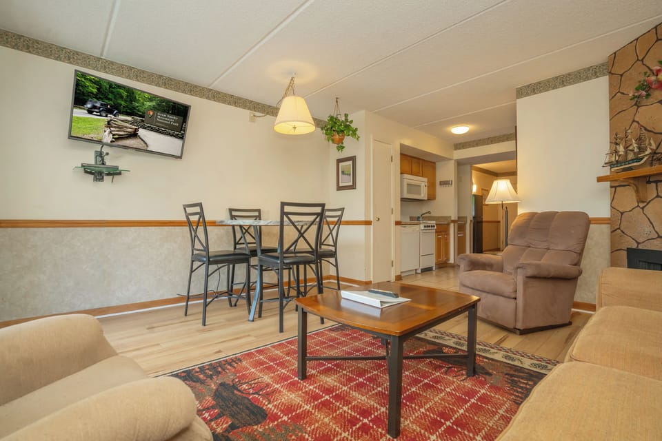 Settle into your inviting living space, where comfortable seating and a warm dining area create the perfect setting for relaxed evenings. The open layout connects seamlessly to your kitchen, making it easy to unwind after a day of exploring.