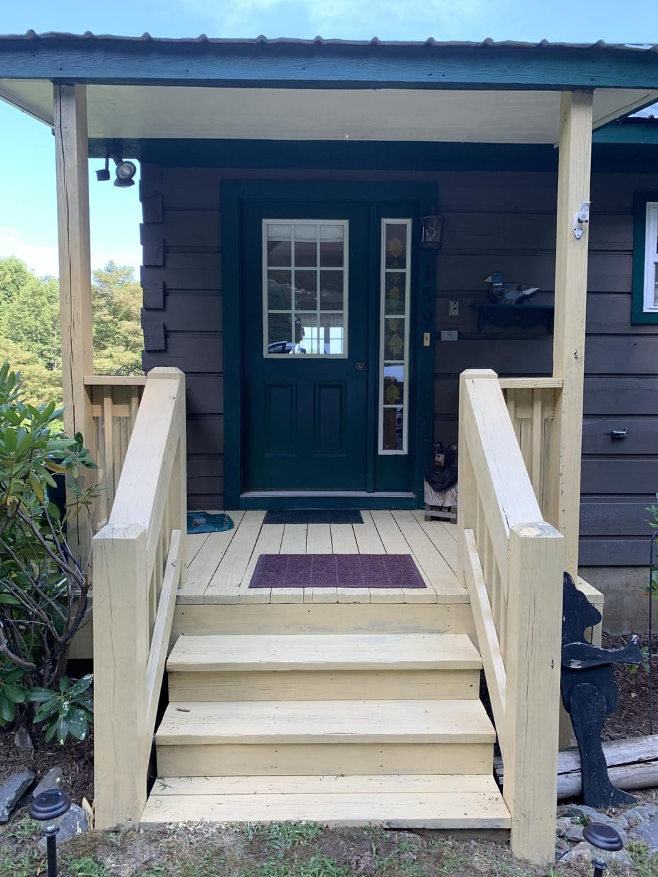 Front porch lock box with key to right of door.