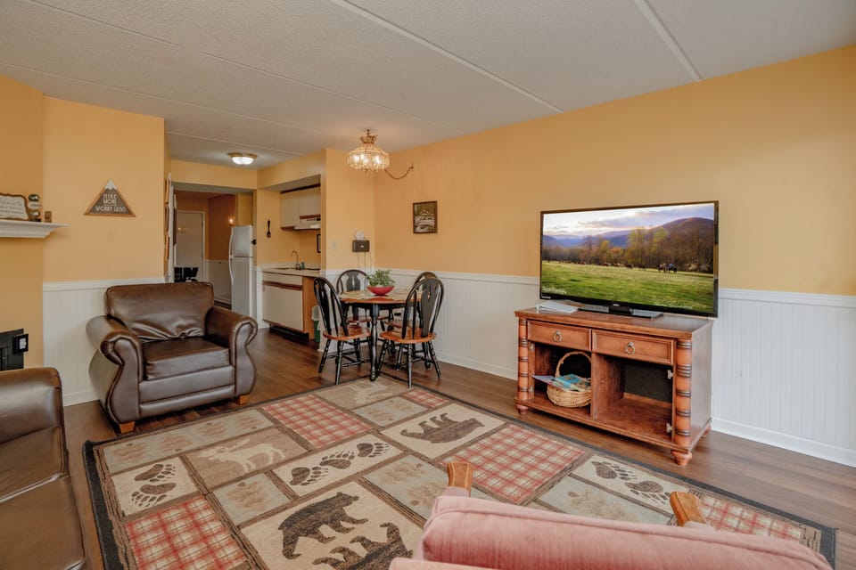 Settle into your cozy living area where warm tones and comfortable seating invite you to relax after a day of adventure. Your open layout flows seamlessly into a dining space and kitchen, perfect for easy living.