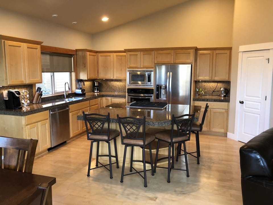 Kitchen has all new, high-end appliances, a huge island, tons of cooking tools.