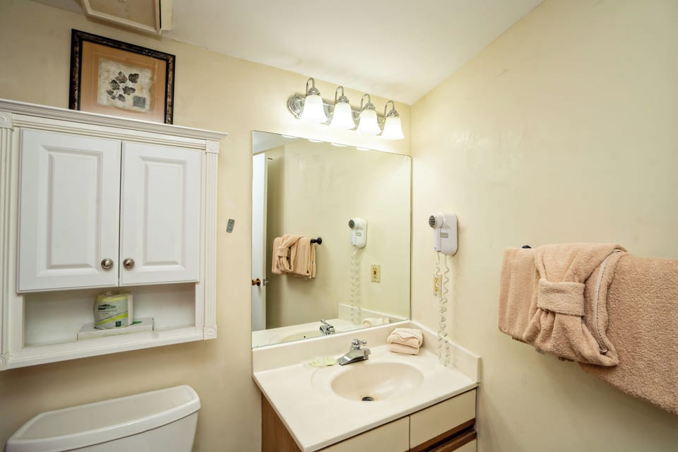 Freshen up in your private bathroom, complete with soft towels, a well-lit vanity, and thoughtful touches like convenient hair dryers.
