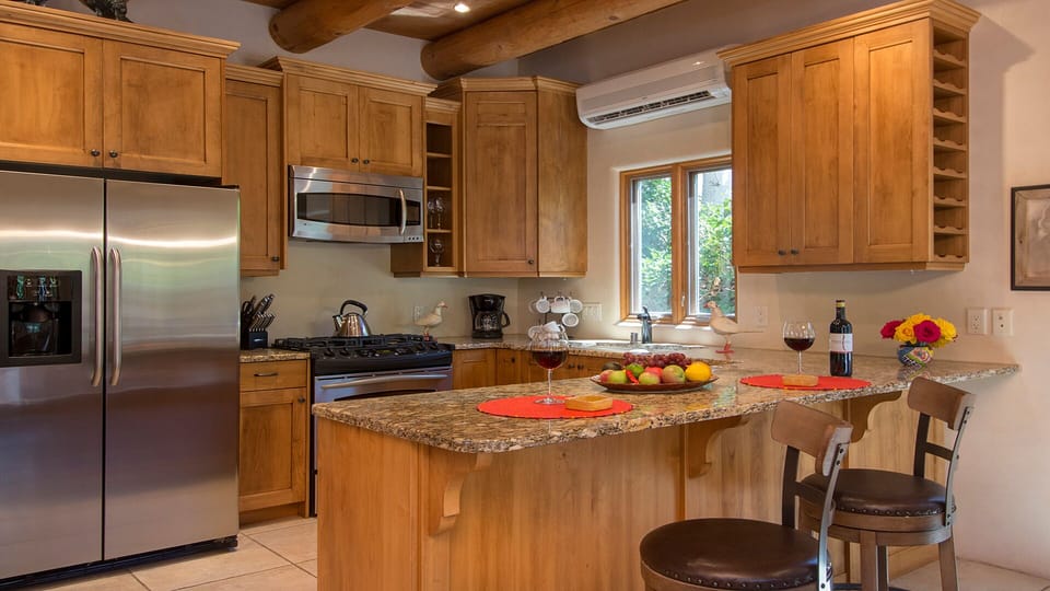 Fully equipped kitchen with stainless steel appliances and breakfast bar