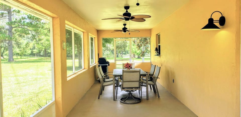 Huge Screened porch with table, chairs, 3 decorator ceiling fans and Gas Grill