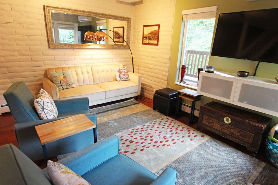 Living room with TV and double doors to patio