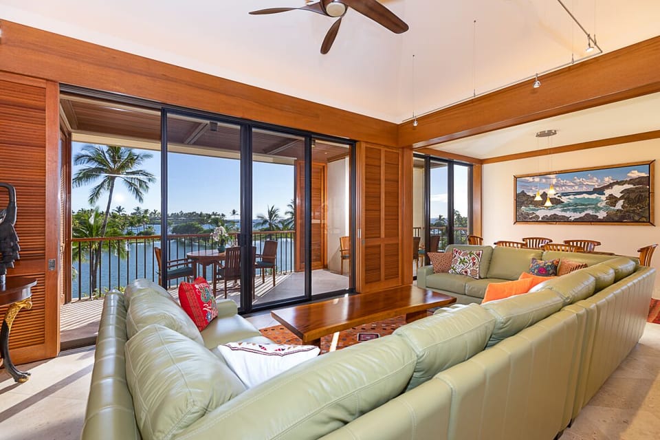 Gather in the spacious living room featuring plush seating, ocean views, and sliding doors that bring the outdoors in.