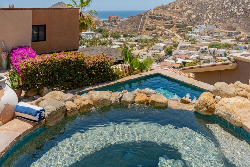 Stone patio with sun deck and pool