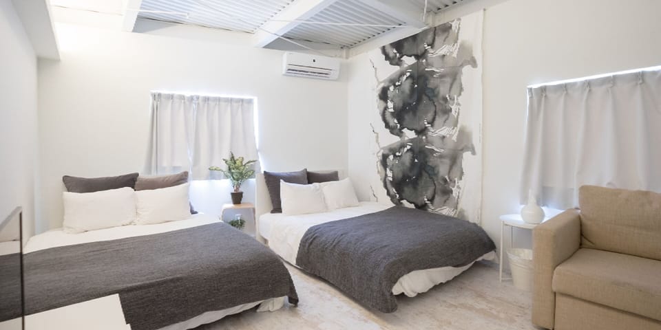 Deluxe Quadruple Room, Multiple Beds, Non Smoking, Shared Bathroom | Laptop workspace, blackout drapes, soundproofing, iron/ironing board