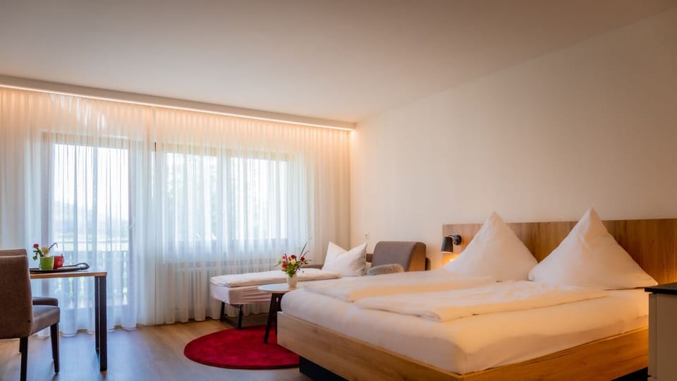 Premium bedding, desk, laptop workspace, blackout drapes
