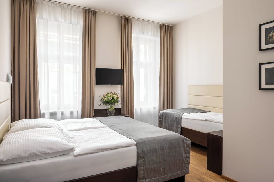 Standard Triple Room | Minibar, in-room safe, iron/ironing board, free WiFi