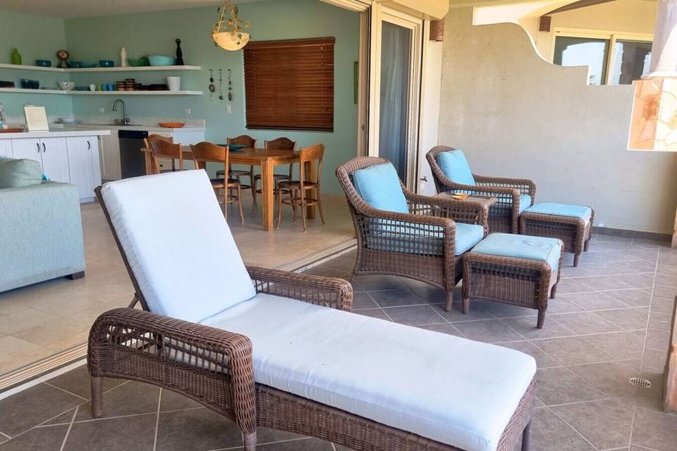 A peaceful balcony retreat with seating and breathtaking sea vistas.