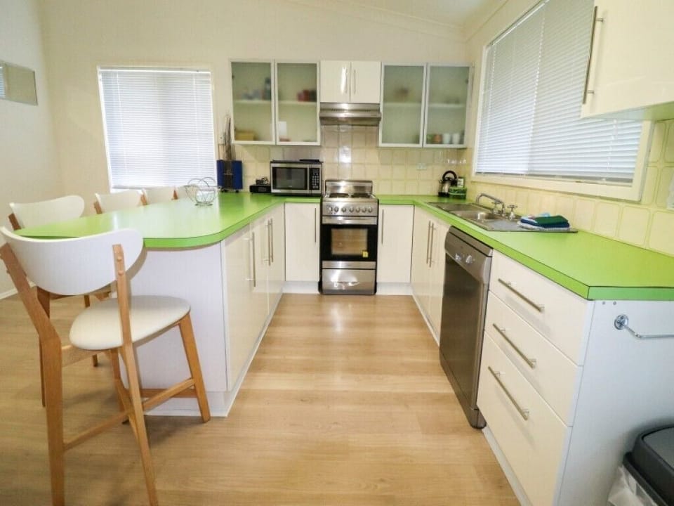 Kitchen with oven, stove, microwave, dishwasher and plenty of bench space
