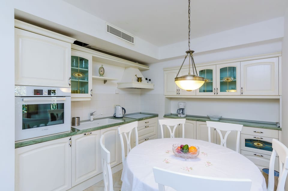 Villa (Four-Bedroom Villa, Swimming Pool) | Private kitchenette | Fridge, stovetop, dishwasher, coffee/tea maker