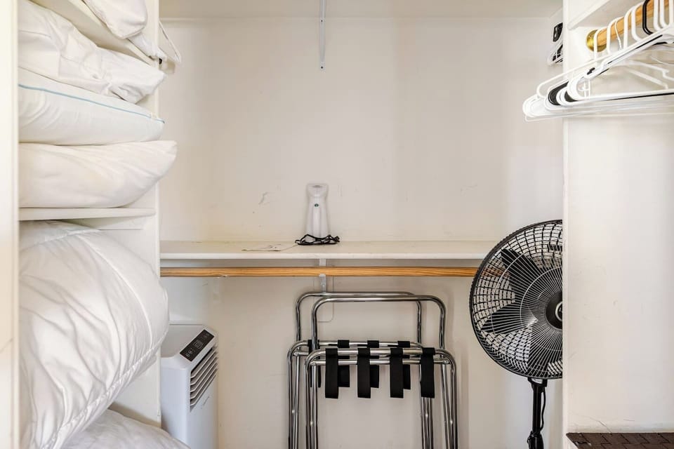 Spacious master closet with plenty of hangers, extra pillows, two luggage racks, and portable air conditioner for those scorching Scottsdale summer days!