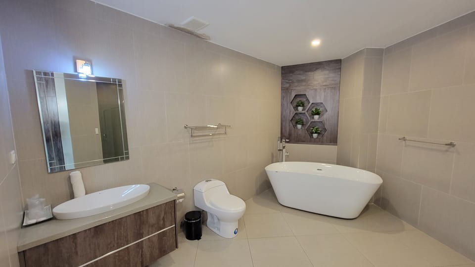 Suite, 1 King Bed, Bathtub | Bathroom | Free toiletries, hair dryer, towels, soap