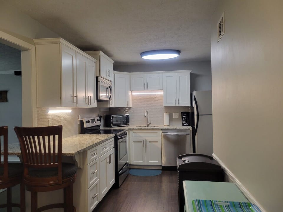 Kitchen view from the dining nook and wrap-around counter with bar stool seating