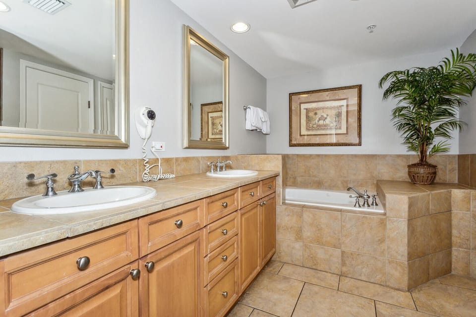 Refresh in your spa-inspired bathroom with dual vanities, a soaking tub, and warm tilework that welcomes you to unwind.