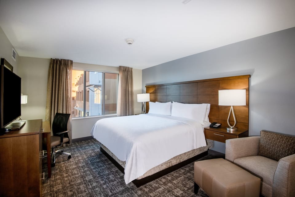 Premium bedding, desk, laptop workspace, blackout drapes