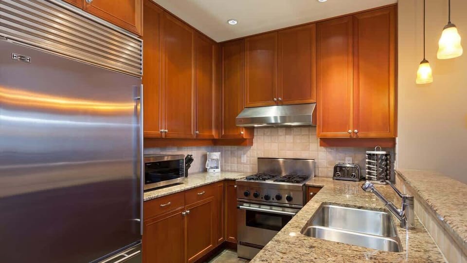 - Sleek kitchen with stainless steel appliances and granite countertops  
- Wooden cabinetry and pendant lighting create a warm mountain feel  
- Fully equipped for preparing hearty après-ski or family meals  