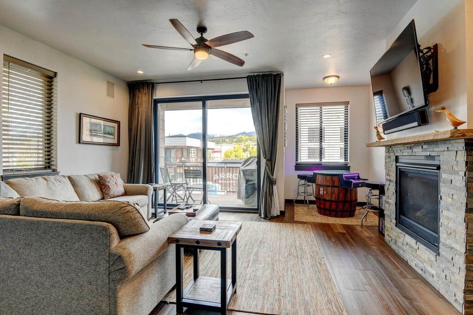 Sectional Sofa, Side Tables, Ceiling Fan, TV, Fireplace, and Arcade.